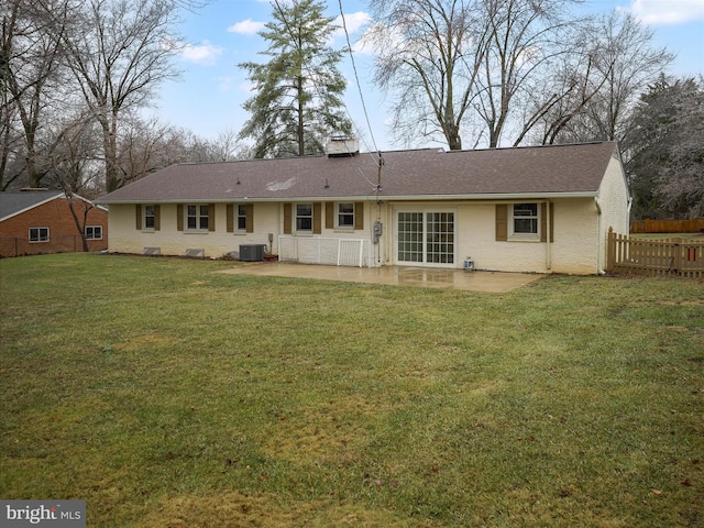 back of house featuring a yard, central AC unit, and a patio area