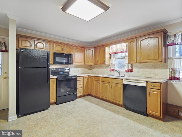 kitchen with sink, crown molding, black appliances, and decorative backsplash