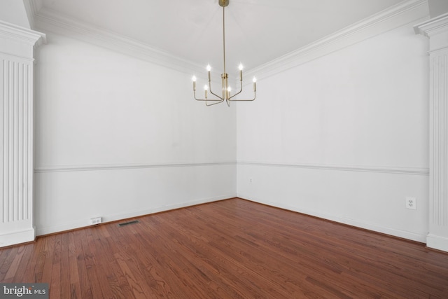 unfurnished room with a chandelier, ornamental molding, wood finished floors, and baseboards