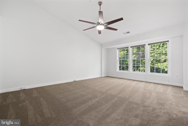 spare room with lofted ceiling, carpet flooring, ceiling fan, and baseboards