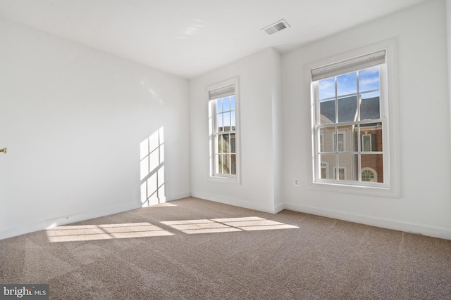 carpeted spare room with baseboards