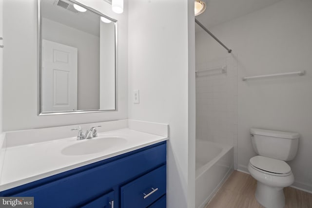 bathroom with toilet, vanity, and shower / tub combination