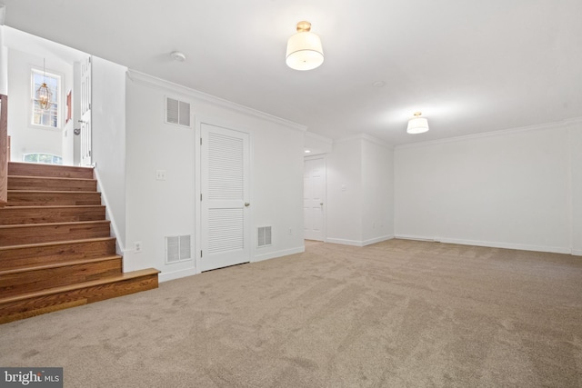basement with ornamental molding, carpet flooring, stairs, and baseboards