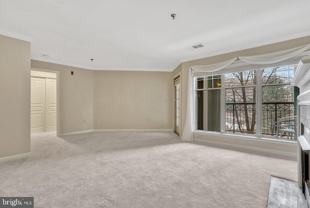 spare room with crown molding and light colored carpet