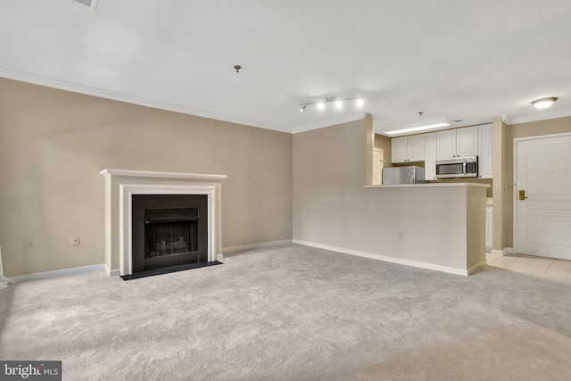 unfurnished living room featuring ornamental molding and light carpet