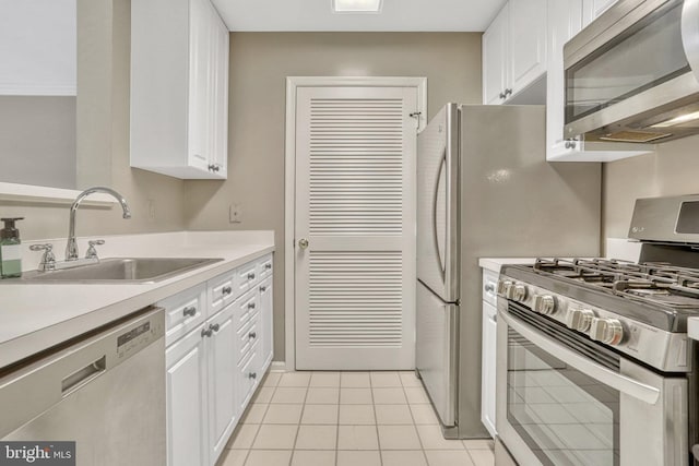 kitchen featuring stainless steel appliances, white cabinetry, sink, and light tile patterned floors