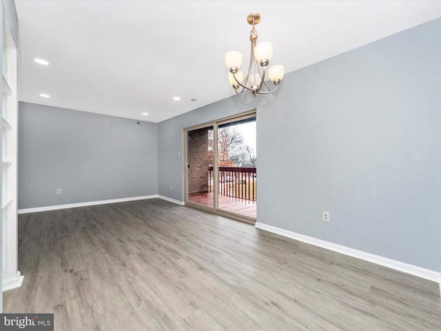 interior space with an inviting chandelier and hardwood / wood-style floors