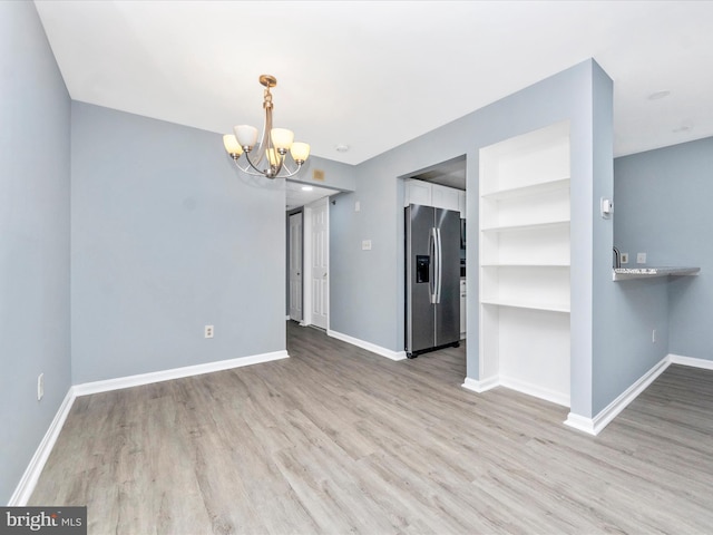 interior space with a chandelier and light hardwood / wood-style flooring