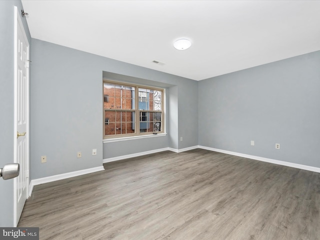 spare room featuring hardwood / wood-style floors