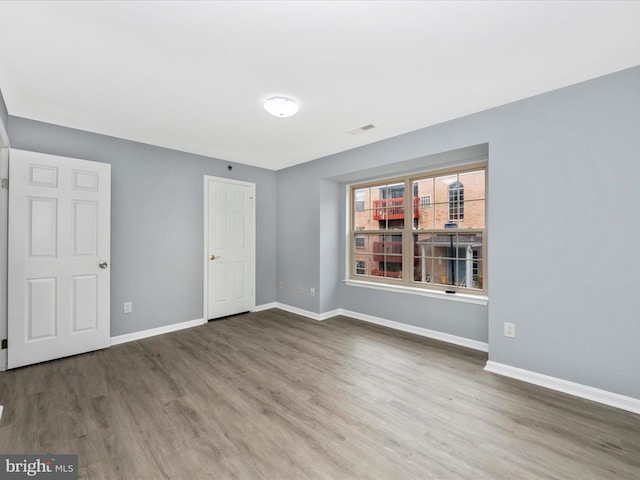 unfurnished bedroom with hardwood / wood-style floors