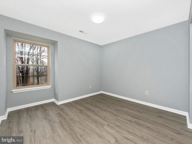 empty room with wood-type flooring