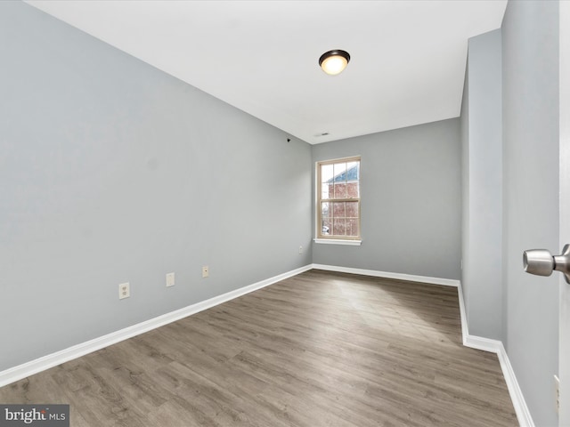 unfurnished room with wood-type flooring