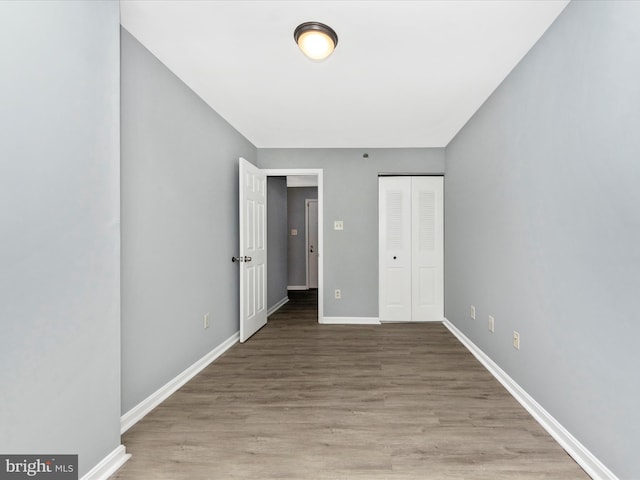 unfurnished bedroom with light hardwood / wood-style flooring and a closet