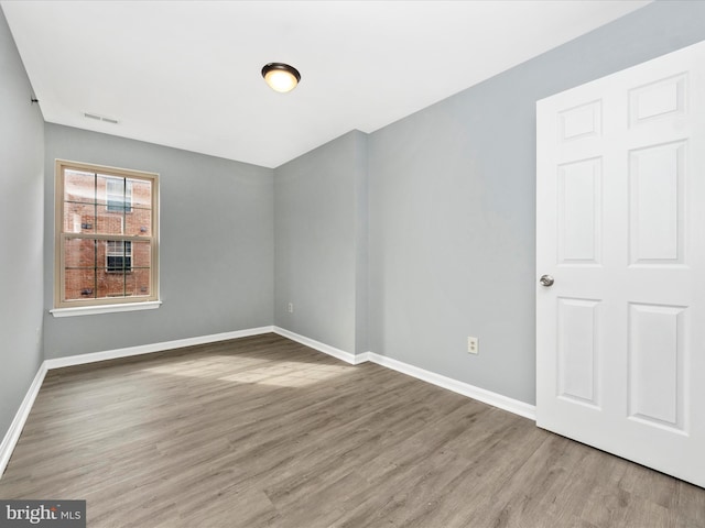 spare room with hardwood / wood-style floors