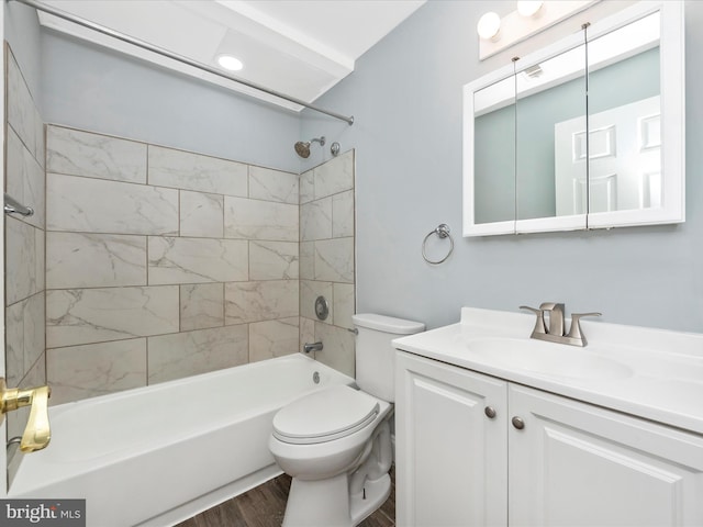 full bathroom featuring vanity, tiled shower / bath combo, wood-type flooring, and toilet