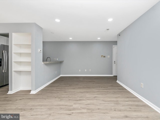 interior space featuring sink and light hardwood / wood-style flooring