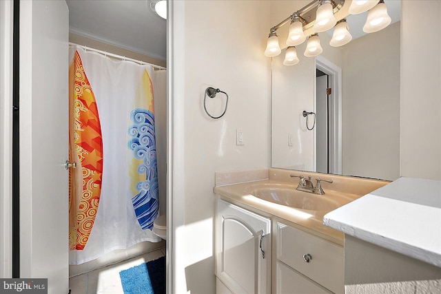 bathroom featuring crown molding and vanity