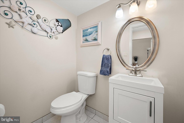 bathroom featuring vanity, tile patterned floors, and toilet