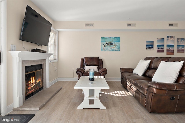 living room with light hardwood / wood-style flooring