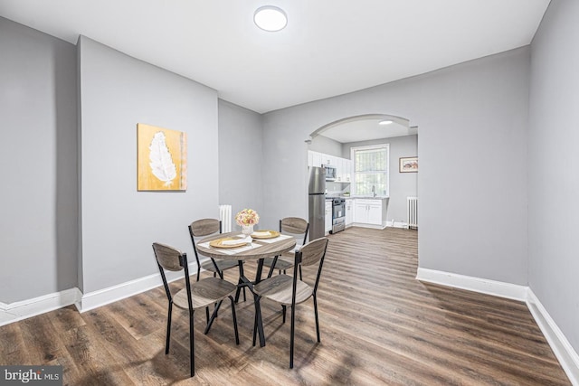 dining space with dark hardwood / wood-style floors