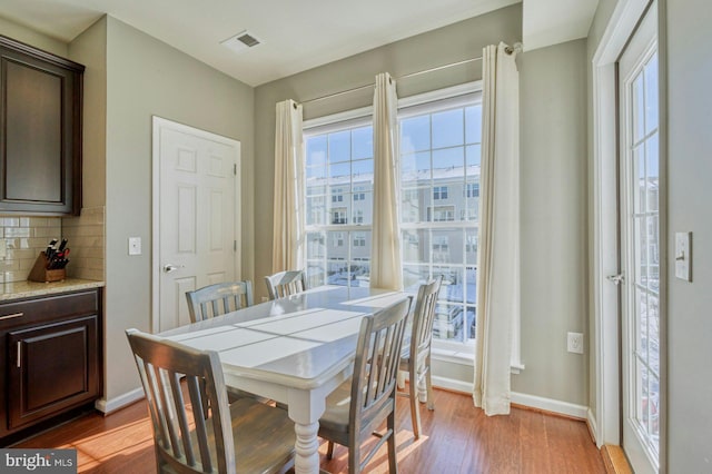 dining space with a healthy amount of sunlight and light wood-type flooring