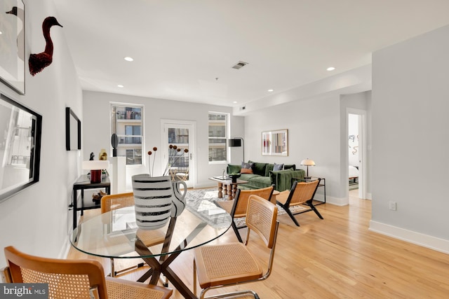 dining room with light wood-style floors, baseboards, visible vents, and recessed lighting