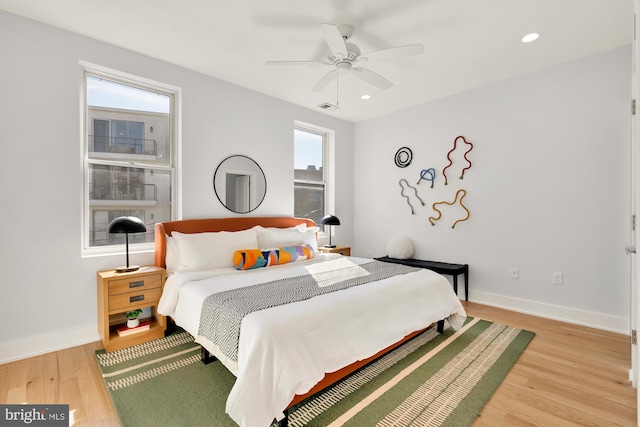 bedroom featuring recessed lighting, wood finished floors, visible vents, and baseboards