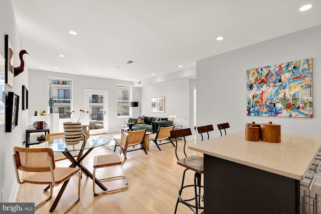 dining room featuring light wood-style floors, baseboards, and recessed lighting