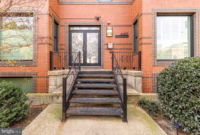 view of exterior entry with french doors and brick siding