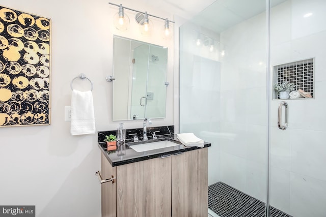 bathroom with vanity and a shower with door