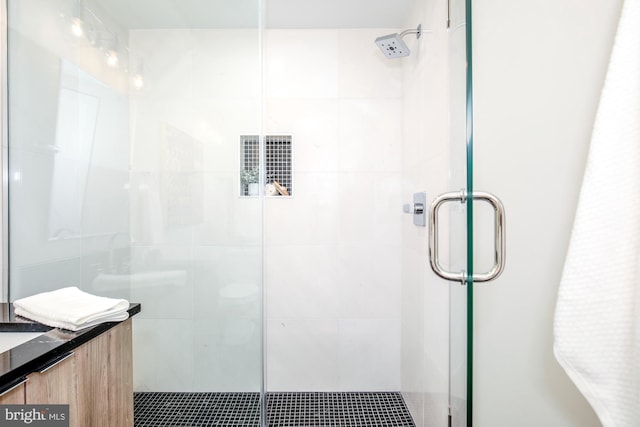 bathroom with vanity and a shower with shower door