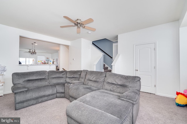 carpeted living room featuring ceiling fan