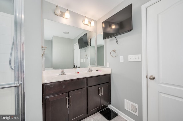 bathroom featuring vanity, tile patterned floors, and a shower with door