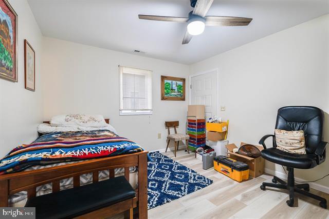 bedroom with ceiling fan and light hardwood / wood-style flooring