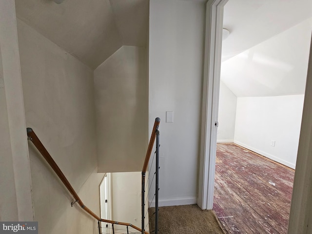 stairs featuring vaulted ceiling