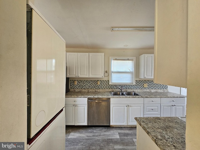 kitchen with white cabinetry, sink, fridge, and dishwasher