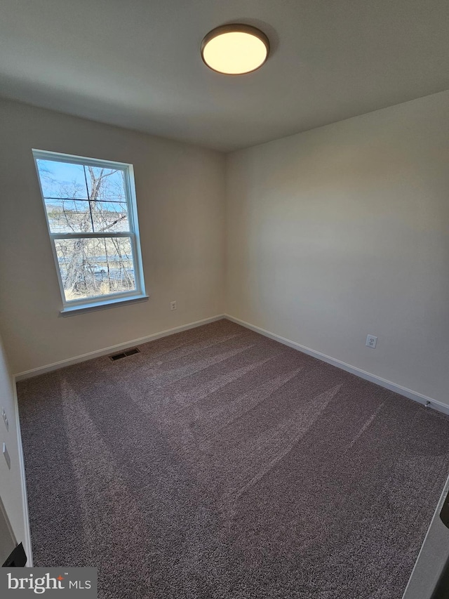 spare room featuring carpet