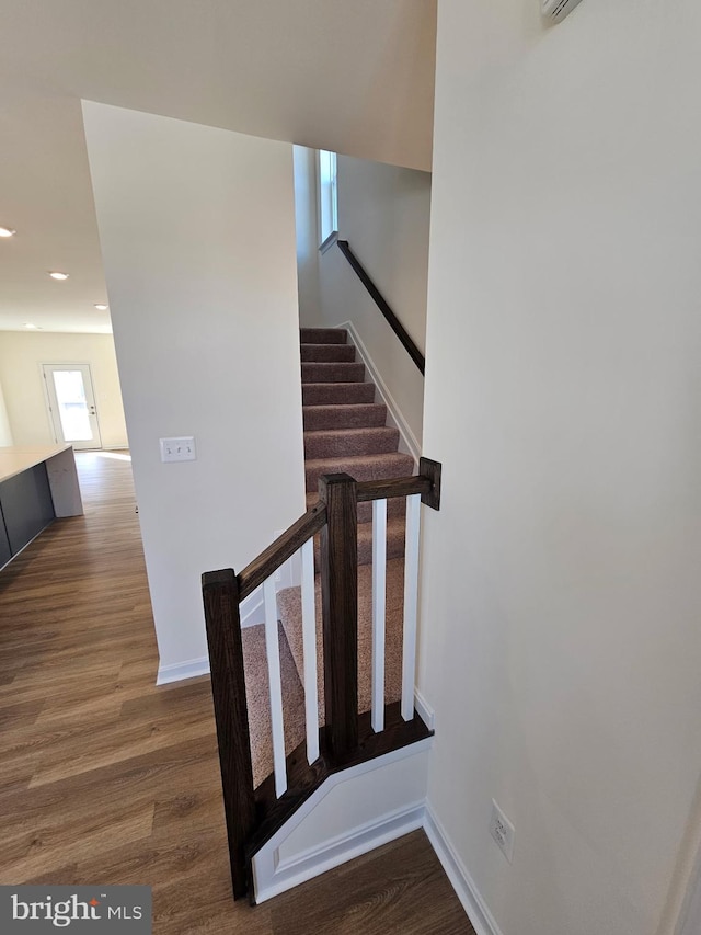 stairway with hardwood / wood-style flooring