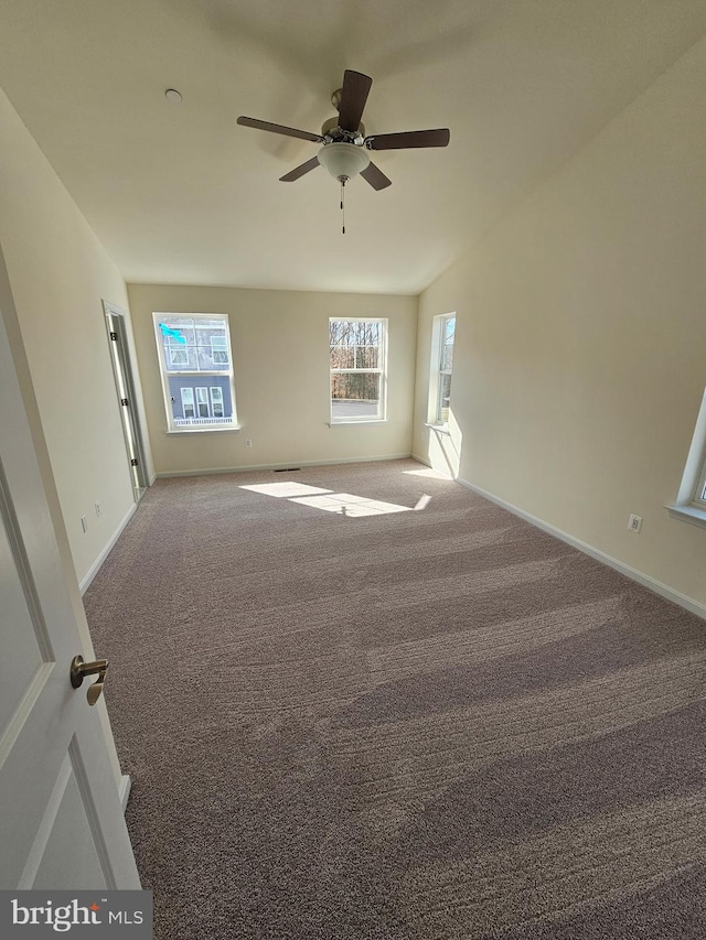 carpeted spare room with ceiling fan