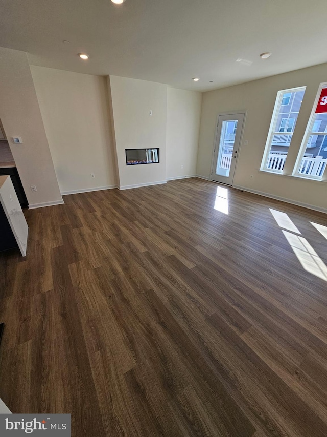 unfurnished living room with dark hardwood / wood-style floors