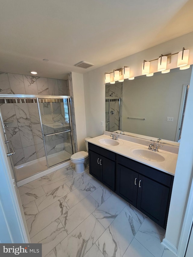 bathroom featuring an enclosed shower, vanity, and toilet