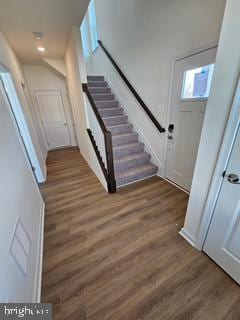 stairs with hardwood / wood-style floors