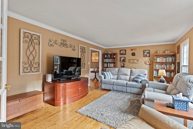 living room with hardwood / wood-style floors and crown molding