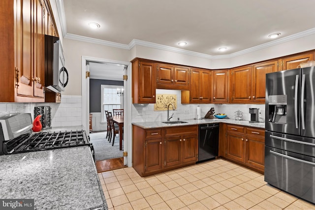 kitchen featuring appliances with stainless steel finishes, light stone countertops, crown molding, backsplash, and sink