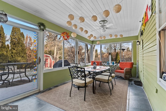 sunroom / solarium featuring ceiling fan and wooden ceiling