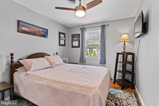 bedroom with ceiling fan and wood-type flooring