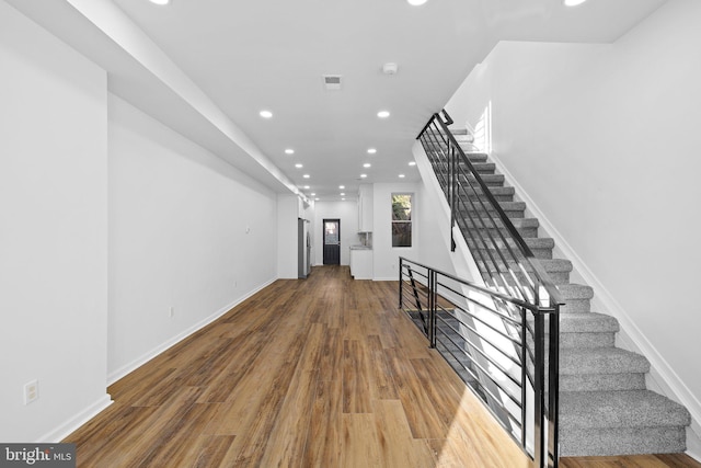 stairs with hardwood / wood-style floors