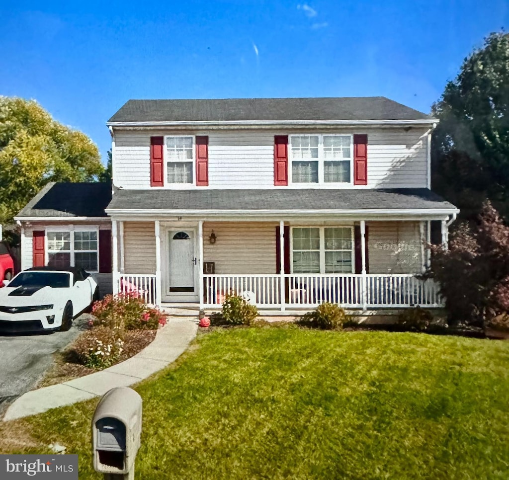 front of property with covered porch and a front lawn