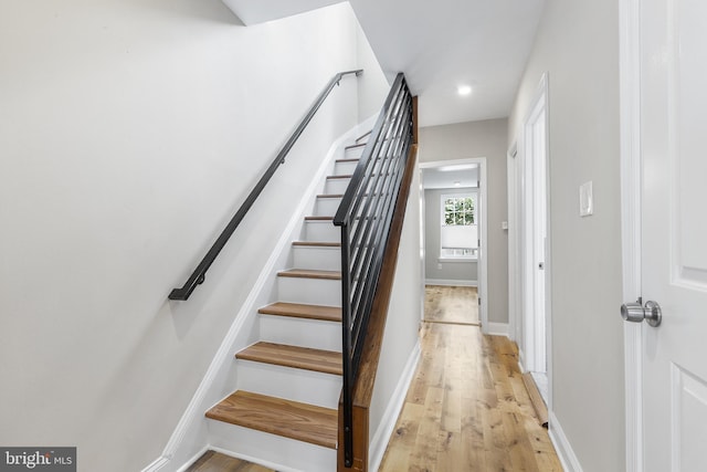 stairs featuring wood-type flooring