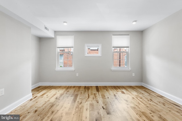 unfurnished room with light wood-type flooring